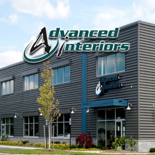 The Advanced Interiors showroom exterior, its sign mounted on the front facade